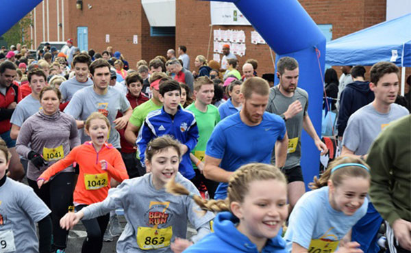 Photo of runners at start of charity run.